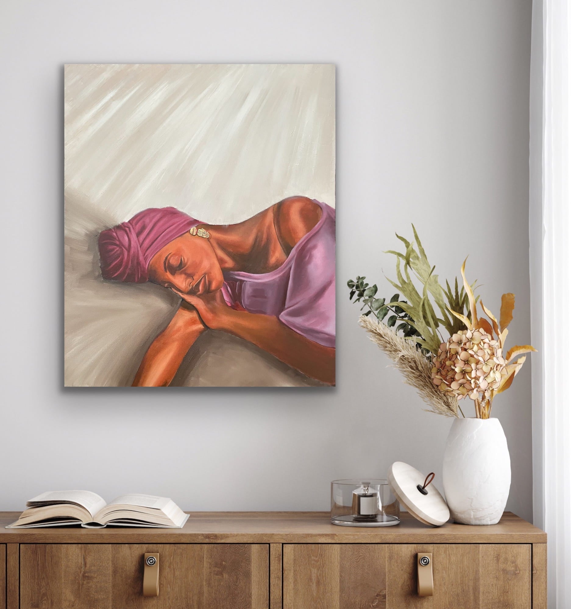 Woman with purple headwrap resting on beige background