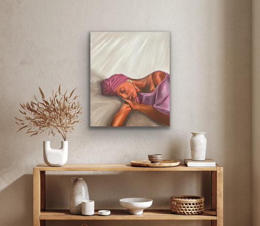 Woman with purple headwrap resting on beige background