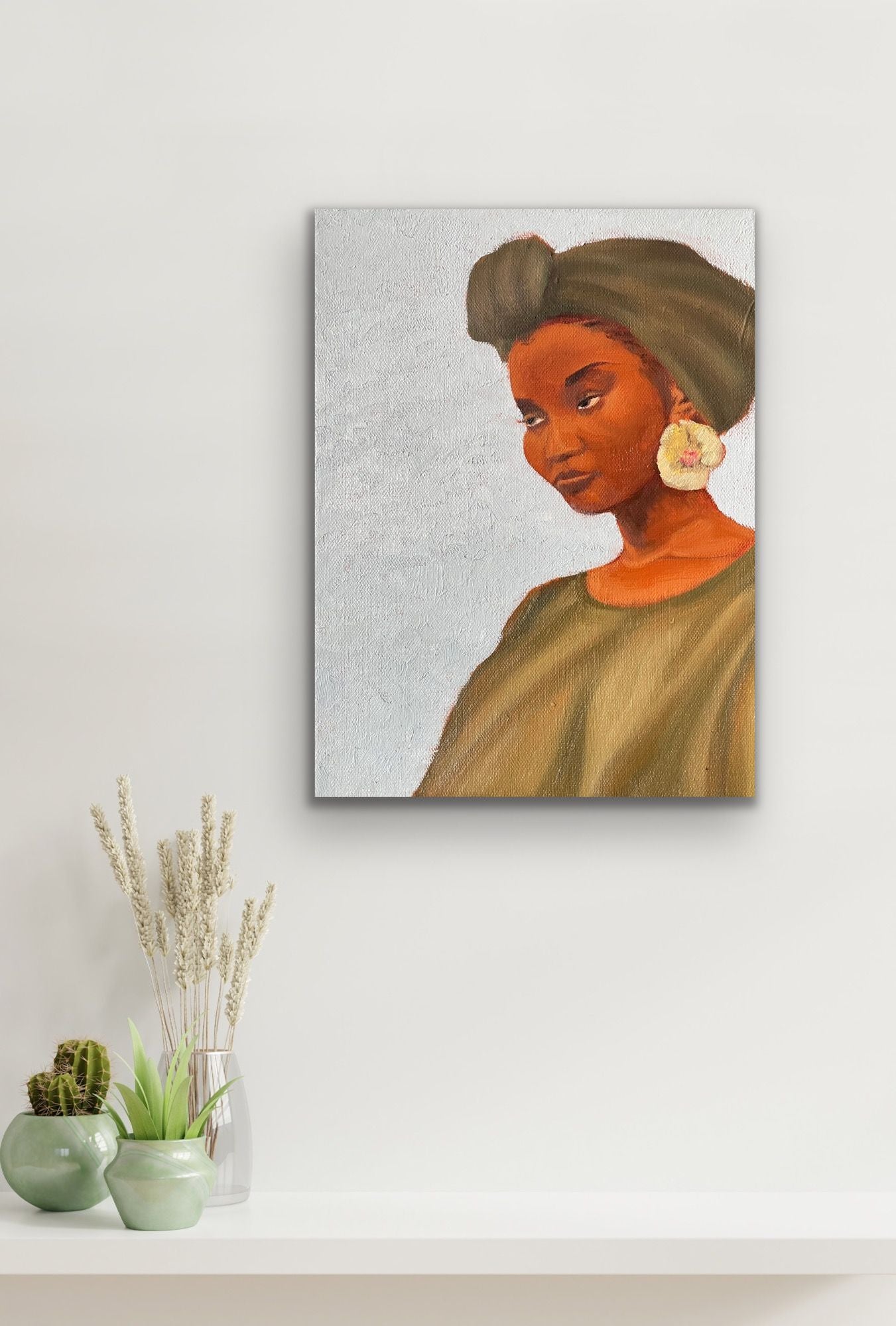 Rock oil painting of woman with green headwrap, dress and flower earring